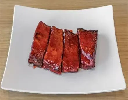 Glazed red BBQ spare ribs on white square plate at Zheng's Chinese Kitchen，a Chinese Restaurant in Goodyear