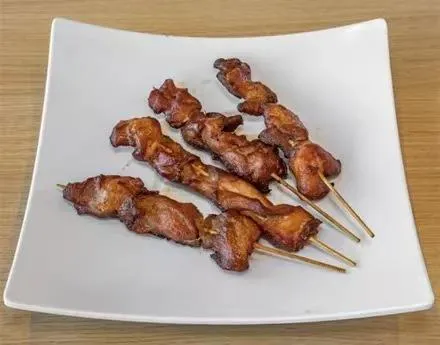 Grilled chicken skewers on a white square plate at Zheng's Chinese Kitchen，a Chinese Restaurant in Goodyear
